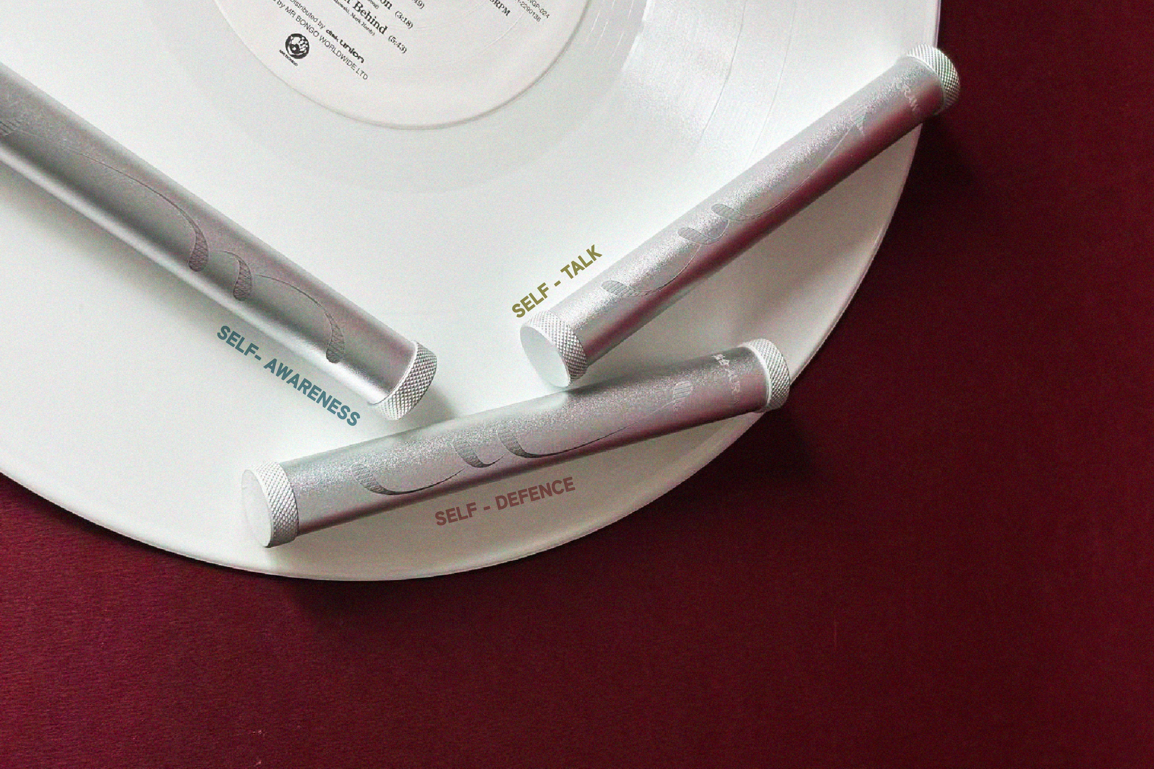 Aurawell self-care wands on a white vinyl record, new coming